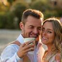 Smiling wedding couple, Emily and Tom, enjoying coffee from Manta Joe cart